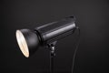 Head of studio flash strobe lamp light. Side view professional studio photography lighting close up on black background Royalty Free Stock Photo