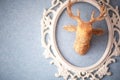 Head of stylized golden reindeer on wall