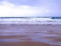 Head on view of the surf and sand at a beach in the South West of the UK Royalty Free Stock Photo