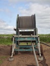 Head on view of the Wright Rain Rainmaker Water Cannon machine with the water pipe coiled onto the drum.