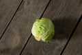 A head of young green cabbage lies on a wooden board Royalty Free Stock Photo
