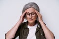 headache. mature grey haired woman experiencing migraine. Upset, frustrated senior woman touching her head suffering Royalty Free Stock Photo