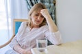 Headache, migraine, depression, problems of a mature woman sitting at home Royalty Free Stock Photo