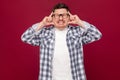 Headache pain or confusion. Portrait of confused middle aged business man in casual checkered shirt and eyeglasses standing and Royalty Free Stock Photo