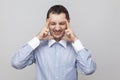 Headache pain. Portrait of angry bristle businessman in classic blue shirt standing holding his painful head, closed eyes and Royalty Free Stock Photo