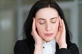 Headache stress tiredness woman massaging temples