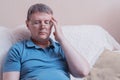 Headache in a tired middle-aged man with glasses Royalty Free Stock Photo