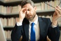 Headache, tiredness and stress. Business man in suit uses a laptop, is tired got headache migraine. Headache pain Royalty Free Stock Photo