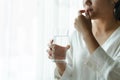 Headache women take medicine with a glass of water, healthcare and medicine recovery concept