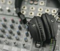 Headband headphones on a mixer with knobs and inserts Royalty Free Stock Photo