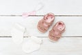 Headband and shoes for baby girl on white wooden background. Fla