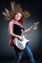 Headbanging woman guitarist playing her guitar Royalty Free Stock Photo