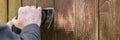 Header, Carpenter is sanding weathered wooden boards with a electric sander Royalty Free Stock Photo