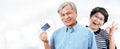 Header of happy asian cheerful senior couple, retirees or older parents smiling and showing credit card with satisfaction in