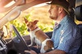 Heading into the city for a drop-off. a man and his dog driving out in the countryside. Royalty Free Stock Photo