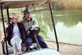 Heading down the fairway. a smiling young couple riding in a cart on a golf course. Royalty Free Stock Photo