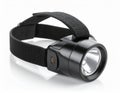 Headlamp with Black Strap and Metal Casing on White Background Royalty Free Stock Photo