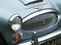 Headlamp and bumper of a blue Austin Healey 3000 Sports car at the Annual Hebden Bridge Vintage Weekend Vehicle Show