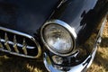 Closeup of the front of a black classic 1950`s car Royalty Free Stock Photo