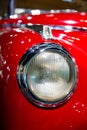 Headlamp from old fashioned, red sports car Royalty Free Stock Photo