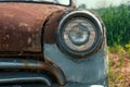 Headlamp of Old retro rusty abandoned car, close up Royalty Free Stock Photo