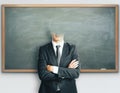 Headless businessman on blackboard background Royalty Free Stock Photo