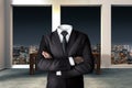 Headless businessman with crossed arms in modern urban office