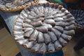 Headless dried fish called Pla Salit on round bamboo basket