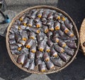 Headless dried fish called Pla Salit on round bamboo basket