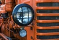 The headlight of abandoned rusty vintage tractor. Small depth of field