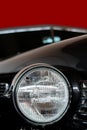 The headlight of an antique, rarity, vintage black car