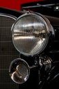 The headlight of an antique, rarity, vintage black car