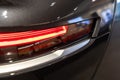 Headlight of black Lucid Air luxury sedan electric vehicle.