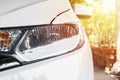 Headlight of city car with sunlight flares