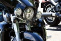 headlight closeup of popular large American made motorcycle. glass lens and shiny chrome finish