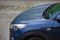 Headlight of a dark car and hood covered with drops of water after rain, close-up Royalty Free Stock Photo