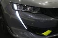 Headlight with elegant sabretooth like daylight LED line on Peugeot 508 SW SPE, powerful french plug-in hybrid large family car Royalty Free Stock Photo