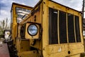 Headlight and front part of an old abandoned broken road construction machine Royalty Free Stock Photo