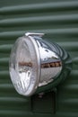 Headlight on the front of a retro green Citroen van. Royalty Free Stock Photo