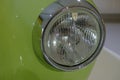 Headlight of a green retro car close-up. Car detail. Transportation. Car repair Royalty Free Stock Photo