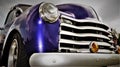 Headlight and Grill of a purple Antique American Pick Up Truck