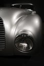 Headlight and grille elegant silver retro car on dark background Royalty Free Stock Photo