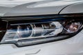 Headlight lamp of new car. Close up detail on one of the LED headlights modern car. Royalty Free Stock Photo