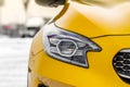 Headlight lamp of new cars. Close up detail on one of the LED headlights modern yellow car. Exterior closeup detail. Closeup headl