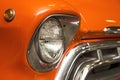 Headlight lamp vintage car. Classic car headlight. Close-up of headlights of orange vintage car. Exhibition Royalty Free Stock Photo