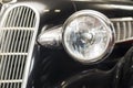 Headlight lamp vintage car. Headlight lamp vintage classic car. Front part with the headlight retro car closeup Royalty Free Stock Photo