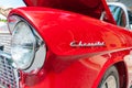 Headlight and logo detail on red Chevrolet