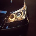 Headlight of a modern black sport car. The front lights of the car. Modern Car exterior details. Royalty Free Stock Photo