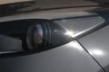 Headlight of a modern gray colored car