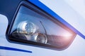 The headlight of a modern high-speed train, with the reflection of a railway station in it. Highlight in the photos Royalty Free Stock Photo